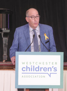 staff member giving a speech at the annual gala